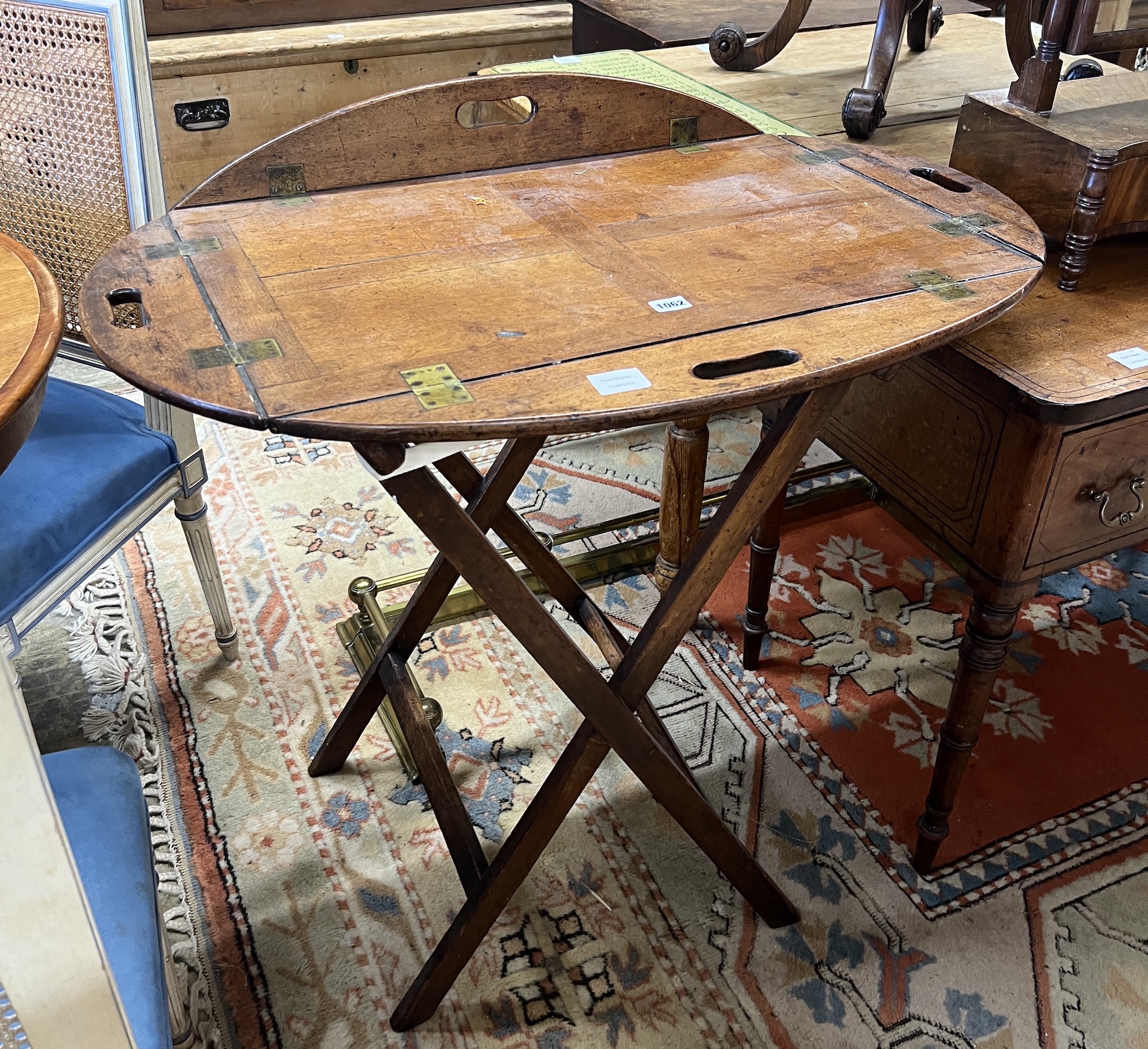 A Victorian brass mounted oval mahogany folding butler's tray / table on stand, width 90cm, height 82cm